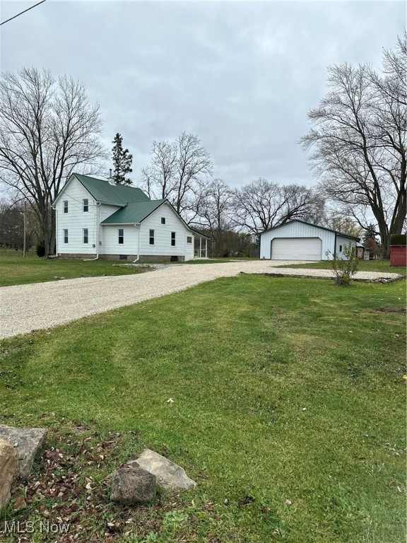 view of yard with an outbuilding and a garage