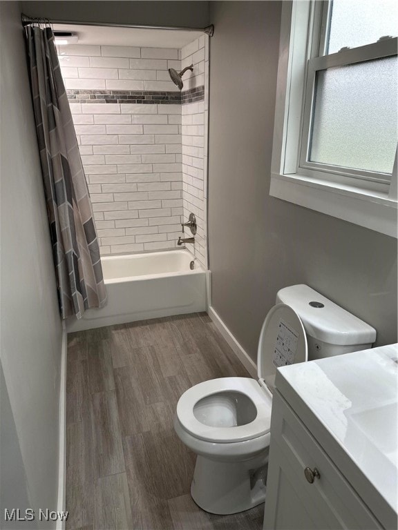 bathroom with shower / bath combo, wood-type flooring, and vanity