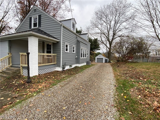 view of home's exterior featuring central AC, covered porch, an outdoor structure, and a garage