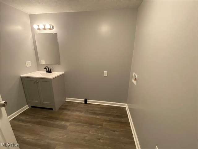 bathroom featuring vanity, a textured ceiling, and hardwood / wood-style flooring