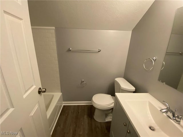 bathroom with hardwood / wood-style floors, vanity, toilet, and a textured ceiling