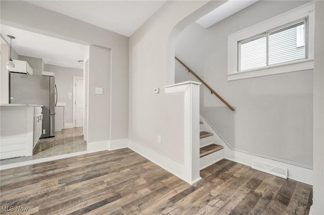 stairway with hardwood / wood-style flooring