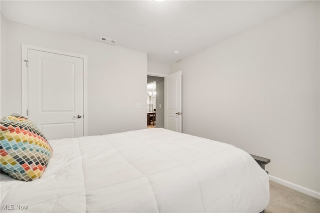 bedroom featuring carpet flooring and a textured ceiling