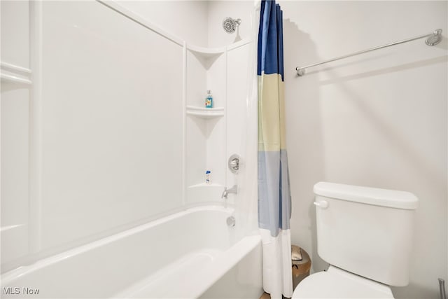 bathroom with shower / bath combo with shower curtain and toilet