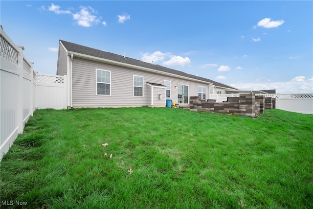 rear view of house with a lawn