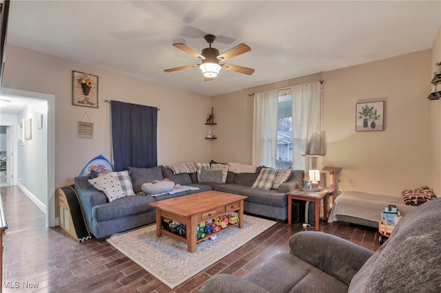 living room featuring ceiling fan and dark wood-type flooring