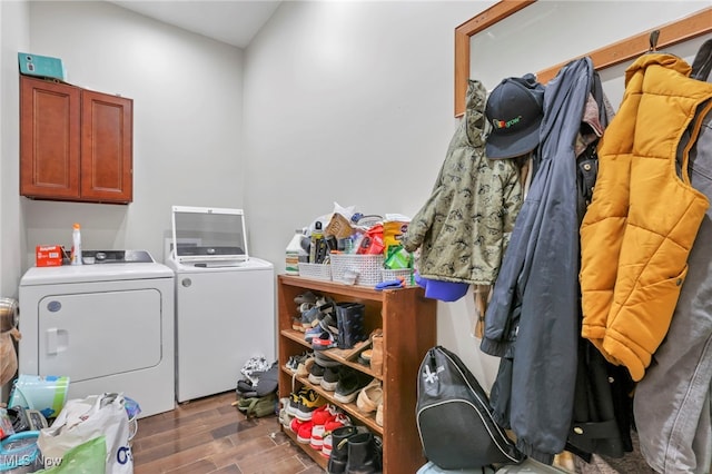 laundry room with cabinets, washing machine and dryer, and dark wood-type flooring