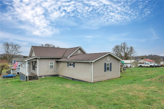 back of property featuring a lawn