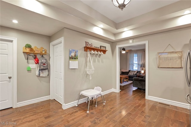 hallway with wood-type flooring