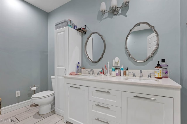 bathroom featuring vanity, a notable chandelier, and toilet