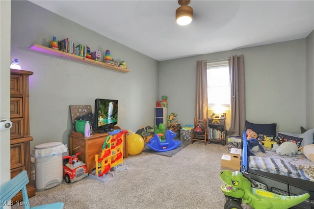 bedroom featuring ceiling fan and carpet