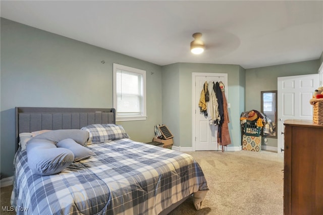 bedroom featuring ceiling fan, carpet floors, and a closet