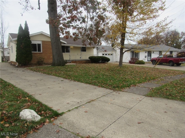 single story home with a garage and a front lawn