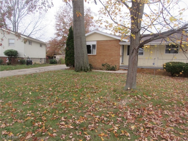 view of side of property with a lawn