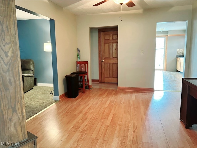 interior space with ceiling fan and light wood-type flooring