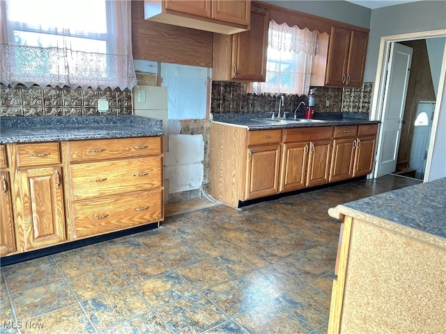 kitchen with decorative backsplash, plenty of natural light, and sink