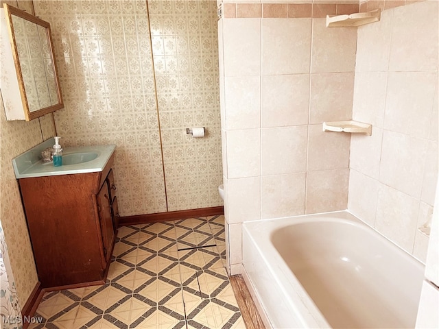 bathroom featuring vanity, a tub to relax in, and tile patterned floors