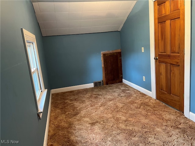 interior space featuring carpet flooring and lofted ceiling