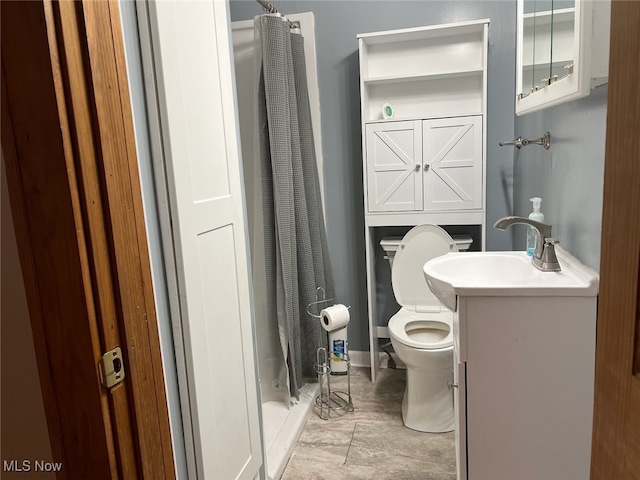 bathroom featuring vanity, toilet, and curtained shower