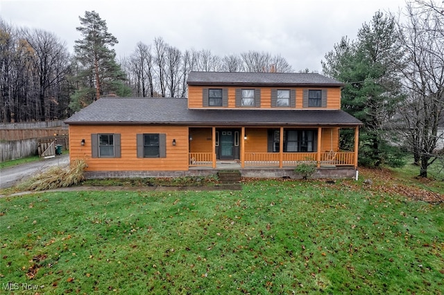 view of front of house with covered porch and a front lawn