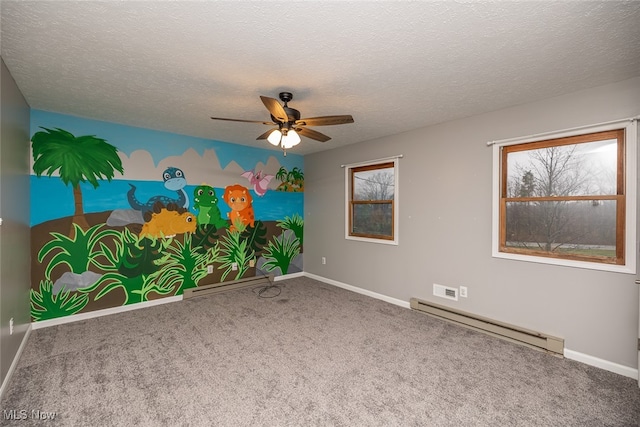 empty room with plenty of natural light, a baseboard radiator, and a textured ceiling