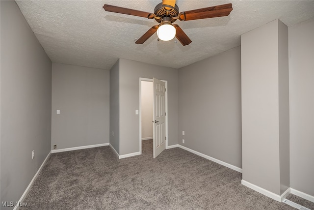 unfurnished bedroom featuring carpet flooring, a textured ceiling, and ceiling fan