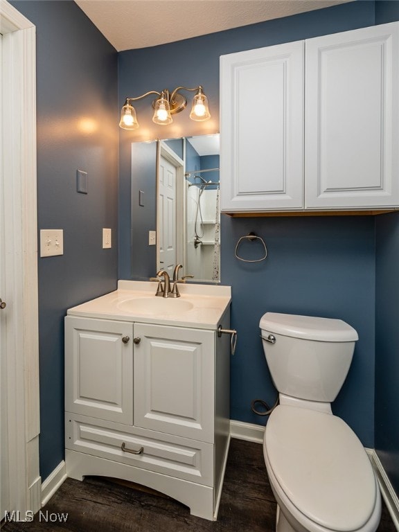 bathroom featuring hardwood / wood-style floors, vanity, and toilet