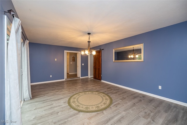 empty room featuring hardwood / wood-style floors and a barn door