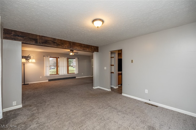 carpeted empty room with beamed ceiling, ceiling fan, and a textured ceiling