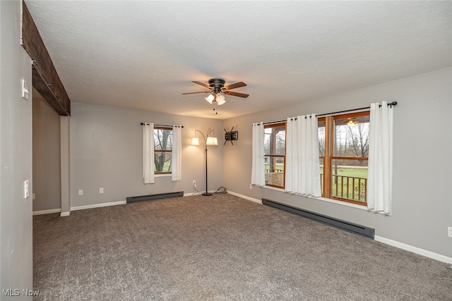 carpeted empty room featuring ceiling fan, a textured ceiling, and a baseboard radiator