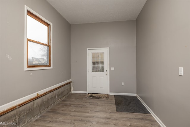 interior space featuring a textured ceiling and light wood-type flooring