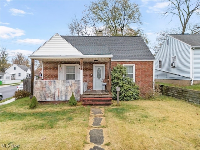 bungalow-style home featuring a front yard