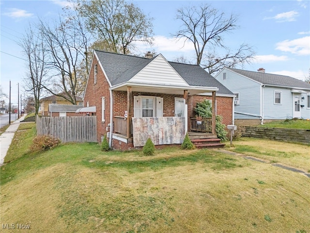 view of front facade featuring a front lawn and covered porch