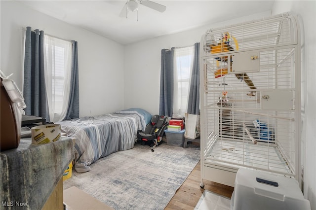 bedroom with ceiling fan and light hardwood / wood-style flooring