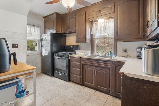 kitchen featuring black appliances, sink, ceiling fan, light tile patterned floors, and dark brown cabinets