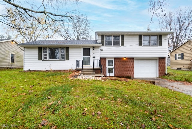 tri-level home featuring a garage and a front yard