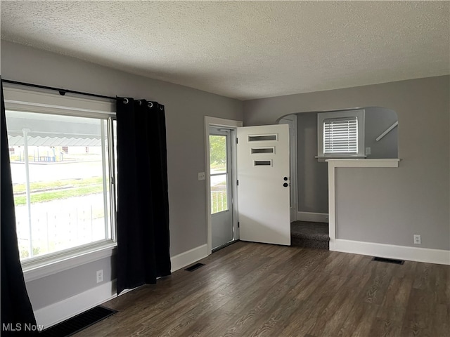 entrance foyer featuring dark hardwood / wood-style flooring and a textured ceiling