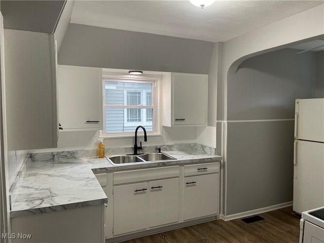 kitchen featuring white cabinetry, sink, dark hardwood / wood-style floors, and white refrigerator