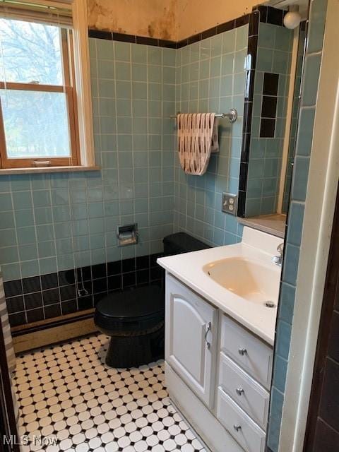 bathroom featuring toilet, vanity, tile patterned flooring, and baseboard heating