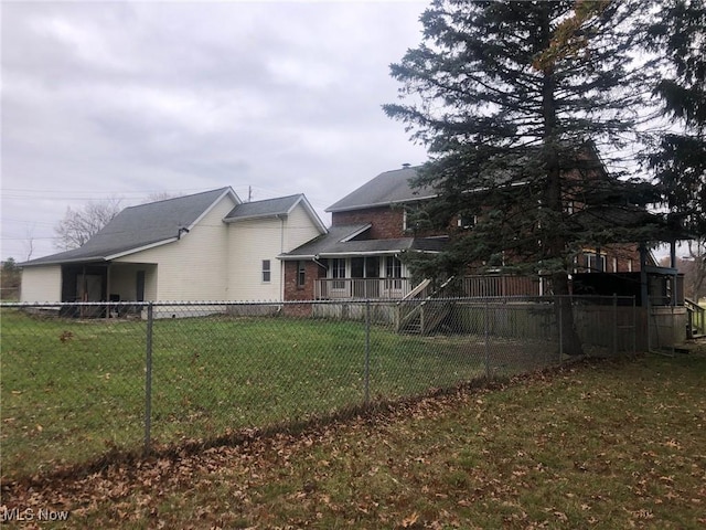 rear view of property with a lawn