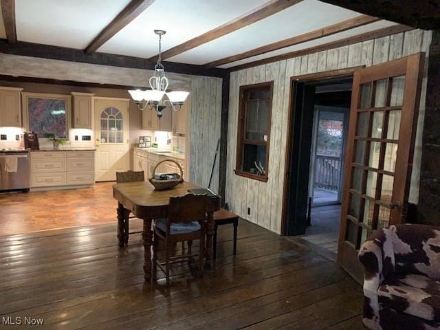 dining room featuring french doors, hardwood / wood-style floors, an inviting chandelier, and beamed ceiling