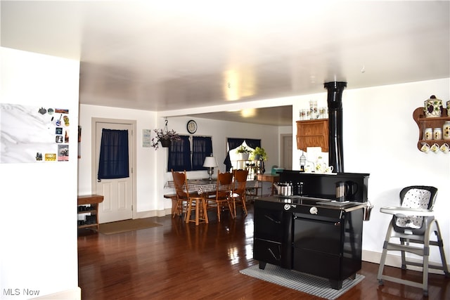 kitchen featuring white fridge and dark wood-type flooring