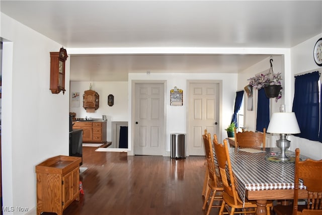 dining room with dark wood-type flooring