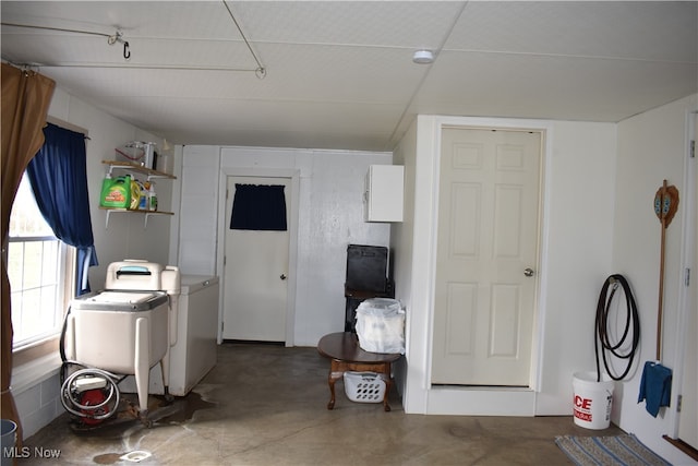 interior space with concrete floors and independent washer and dryer