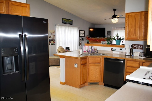 kitchen with kitchen peninsula, vaulted ceiling, ceiling fan, sink, and black appliances