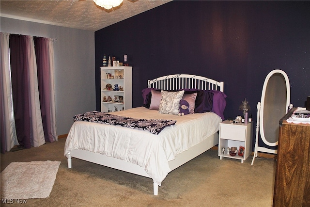 bedroom featuring carpet flooring and a textured ceiling