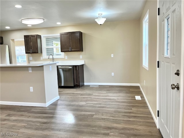 kitchen featuring dishwasher, hardwood / wood-style floors, dark brown cabinetry, and white fridge