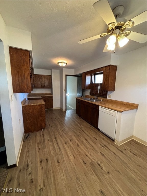 kitchen with ceiling fan, white dishwasher, a textured ceiling, and light wood-type flooring