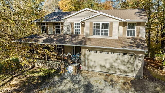 view of front facade featuring a porch and a garage