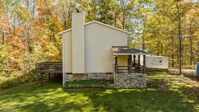 exterior space featuring a lawn and a wooden deck